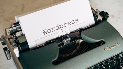 Close-up of a vintage typewriter with paper labeled Wordpress.